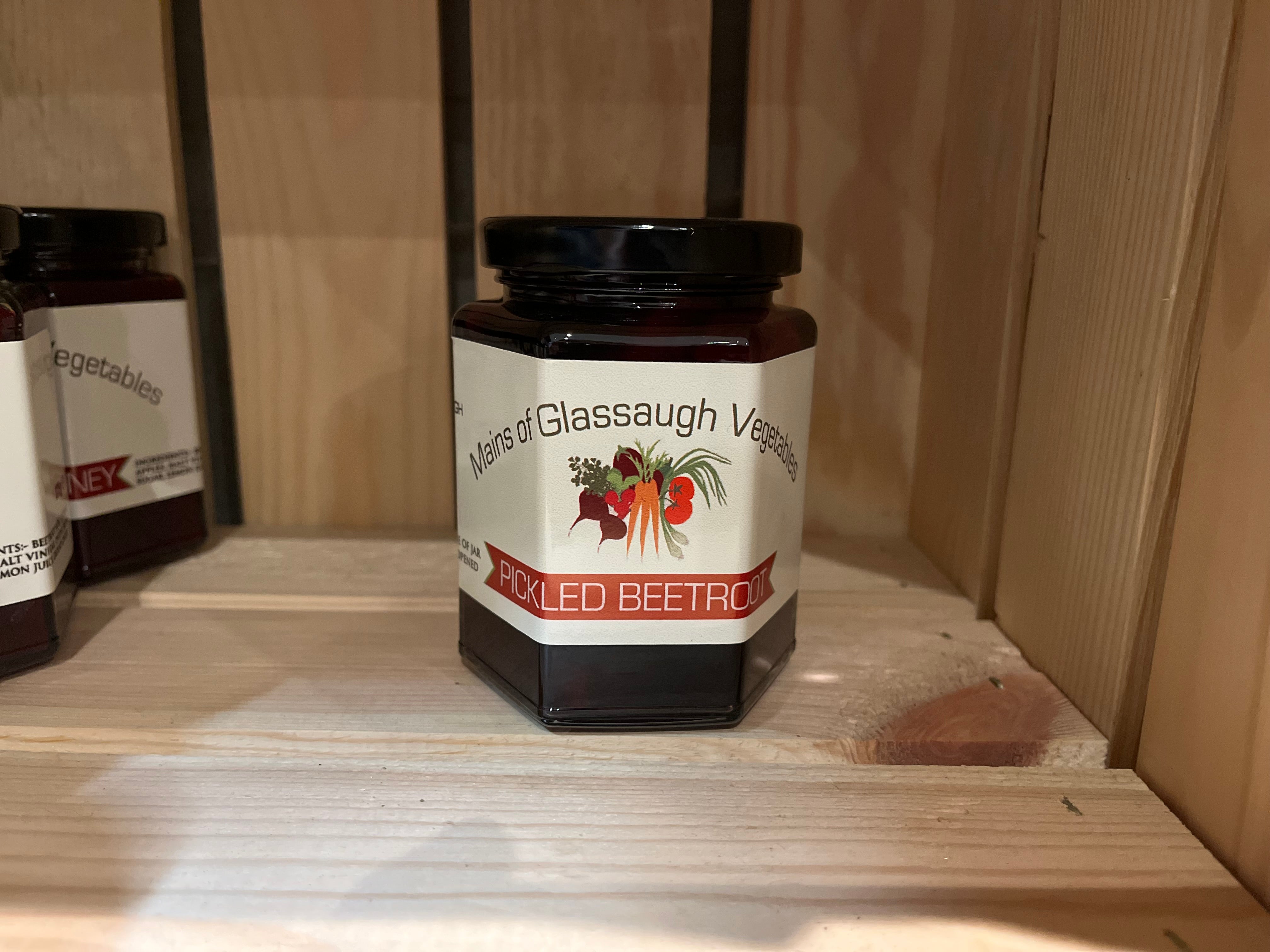 Jar of pickled beetroots on a wooden shelf
